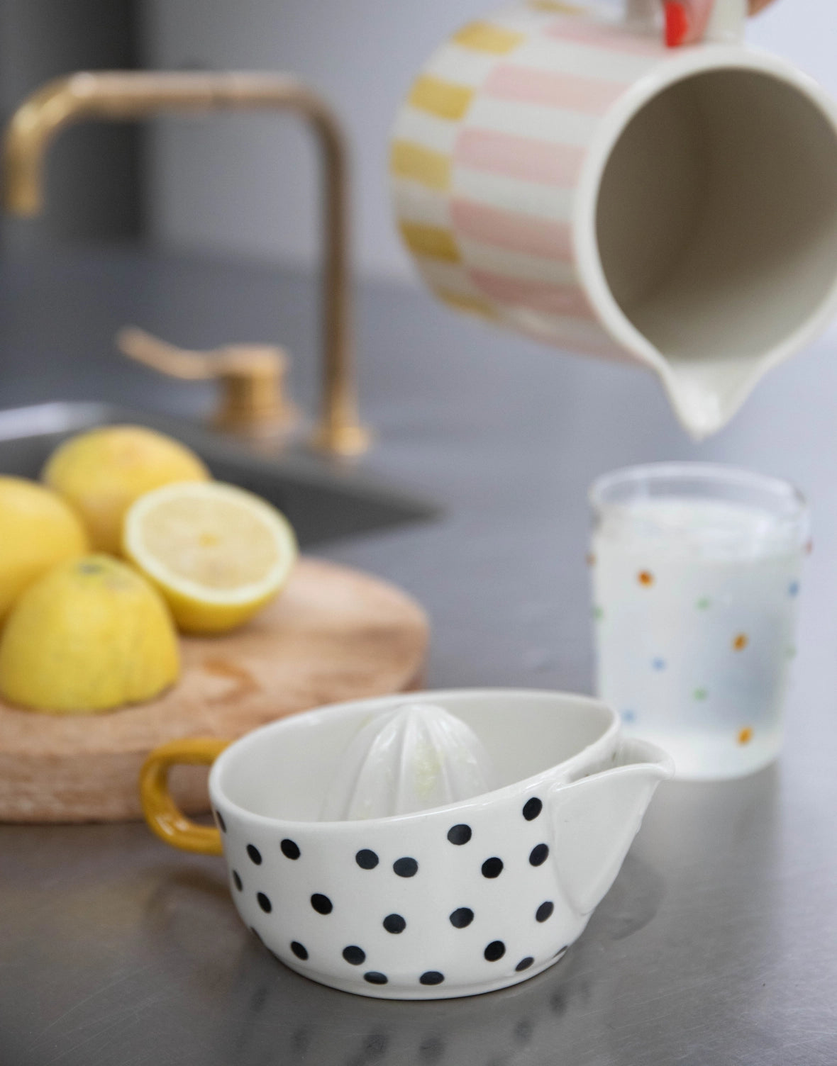 Mono Dots citrus juicer in hand-painted glazed stoneware, yellow handle
